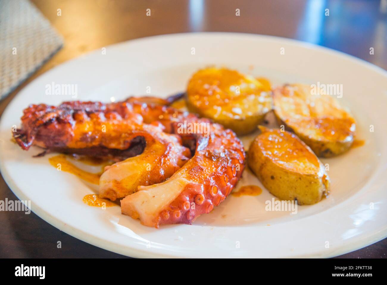 Grilled octopus with potatoes. Spain. Stock Photo