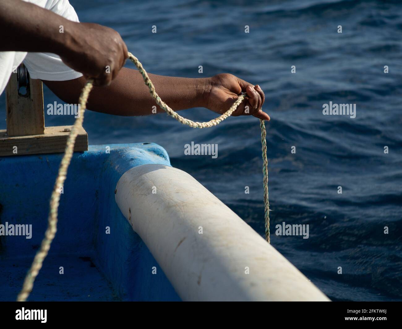 fisherman hands releasing rope Stock Photo - Alamy