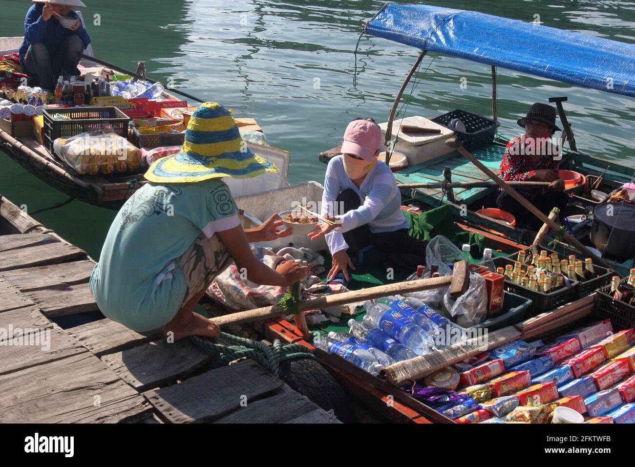 Floating market, vendor in boat with food, Halong Bay, Vietnam Stock
