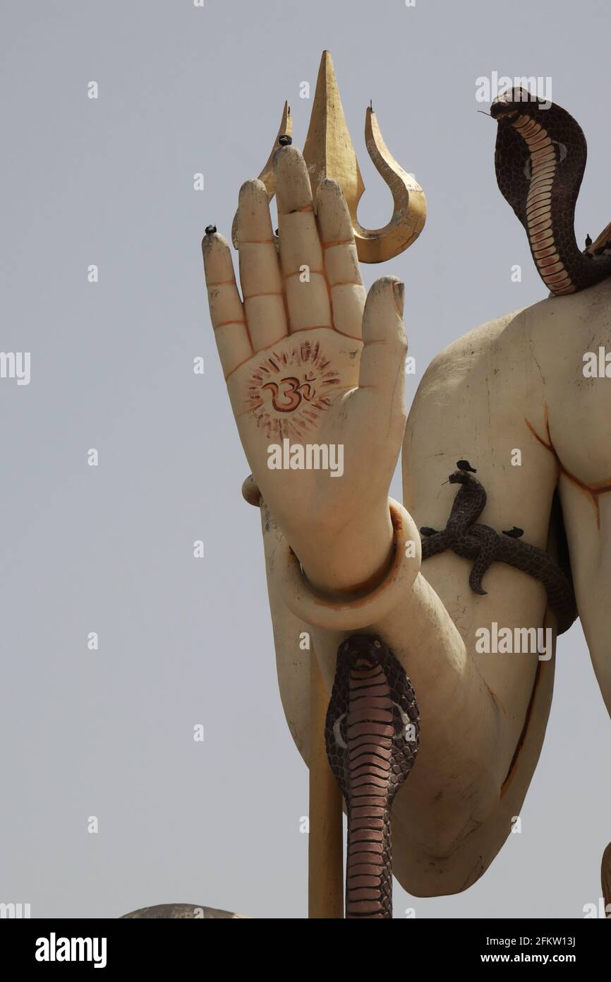 Vertical shot of the hand of the statue of Buddha in Nageshwar Shiva Temple Goriyali in India Stock Photo