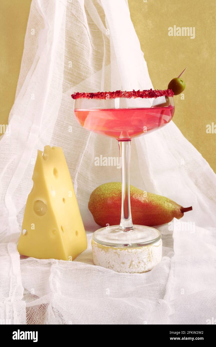 Rose wine cheese and pear still life. Front view against a background of white fabric. Stock Photo