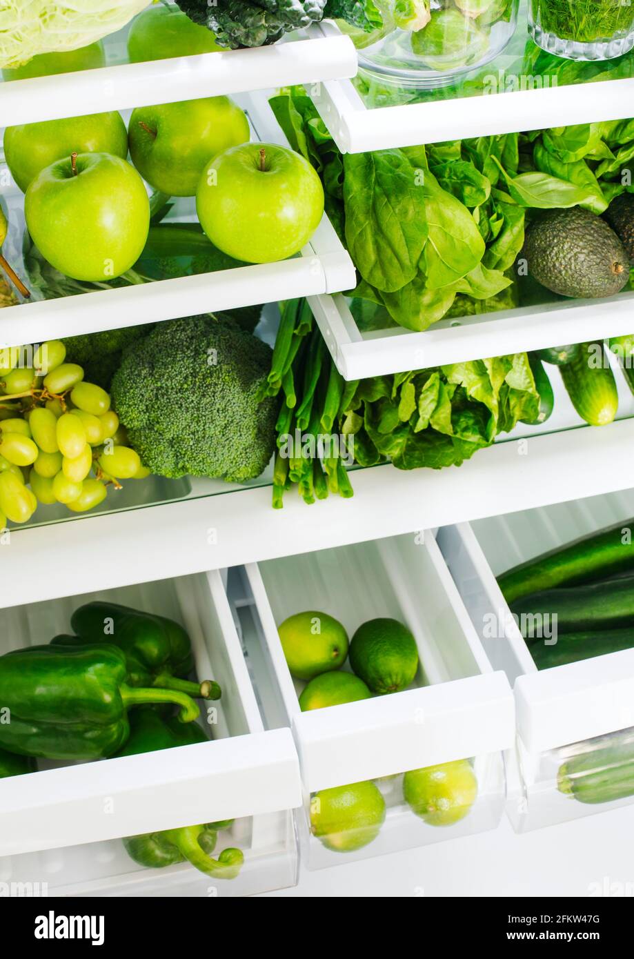 Fresh green vegetables and fruits in fridge. Stock Photo