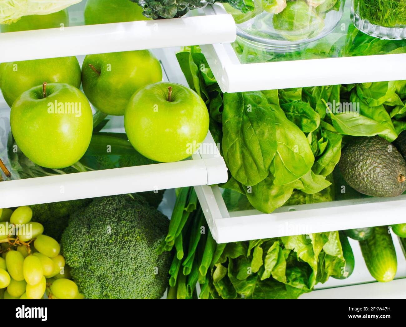 Fresh green vegetables and fruits in fridge. Stock Photo