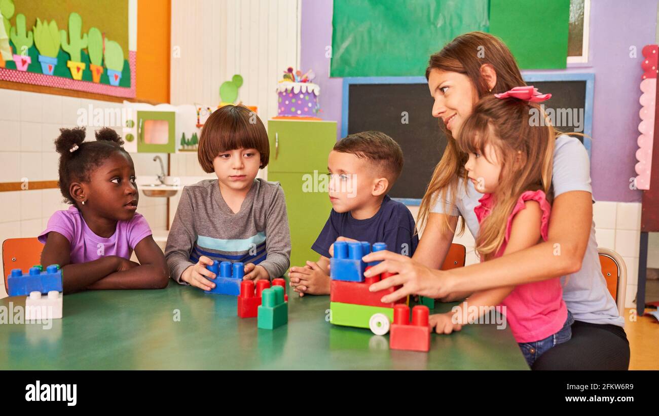 Kindergarten teacher and group of children in international