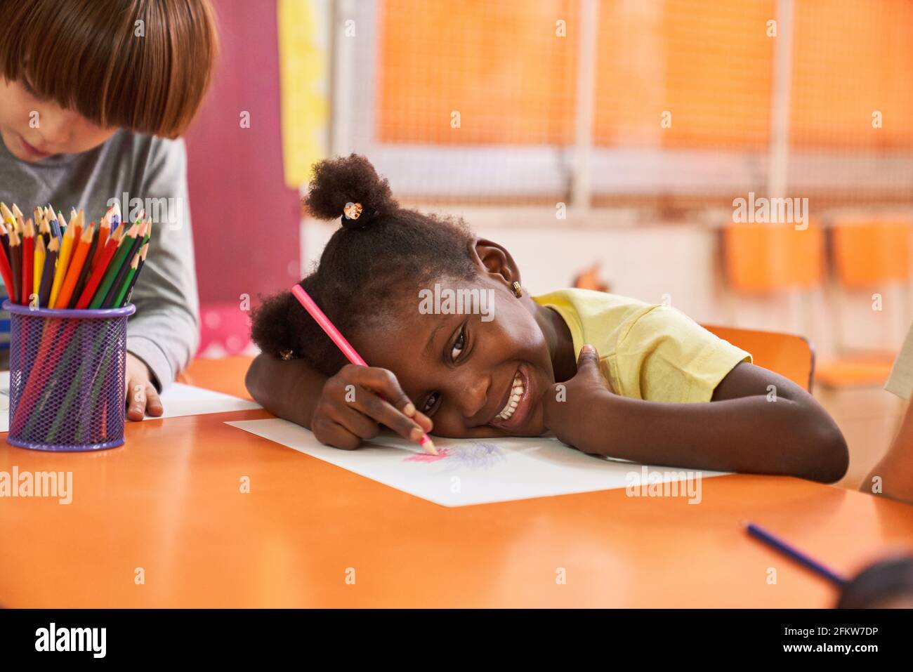 African girl in creative painting class in international kindergarten painting a picture Stock Photo