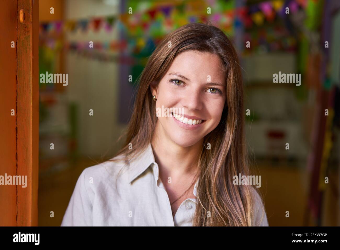 Happy young woman as a kindergarten teacher in a daycare center or school Stock Photo
