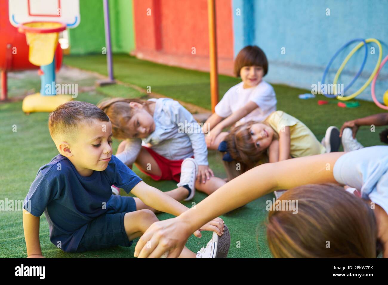 Group of children doing gymnastics together in daycare or preschool Stock Photo
