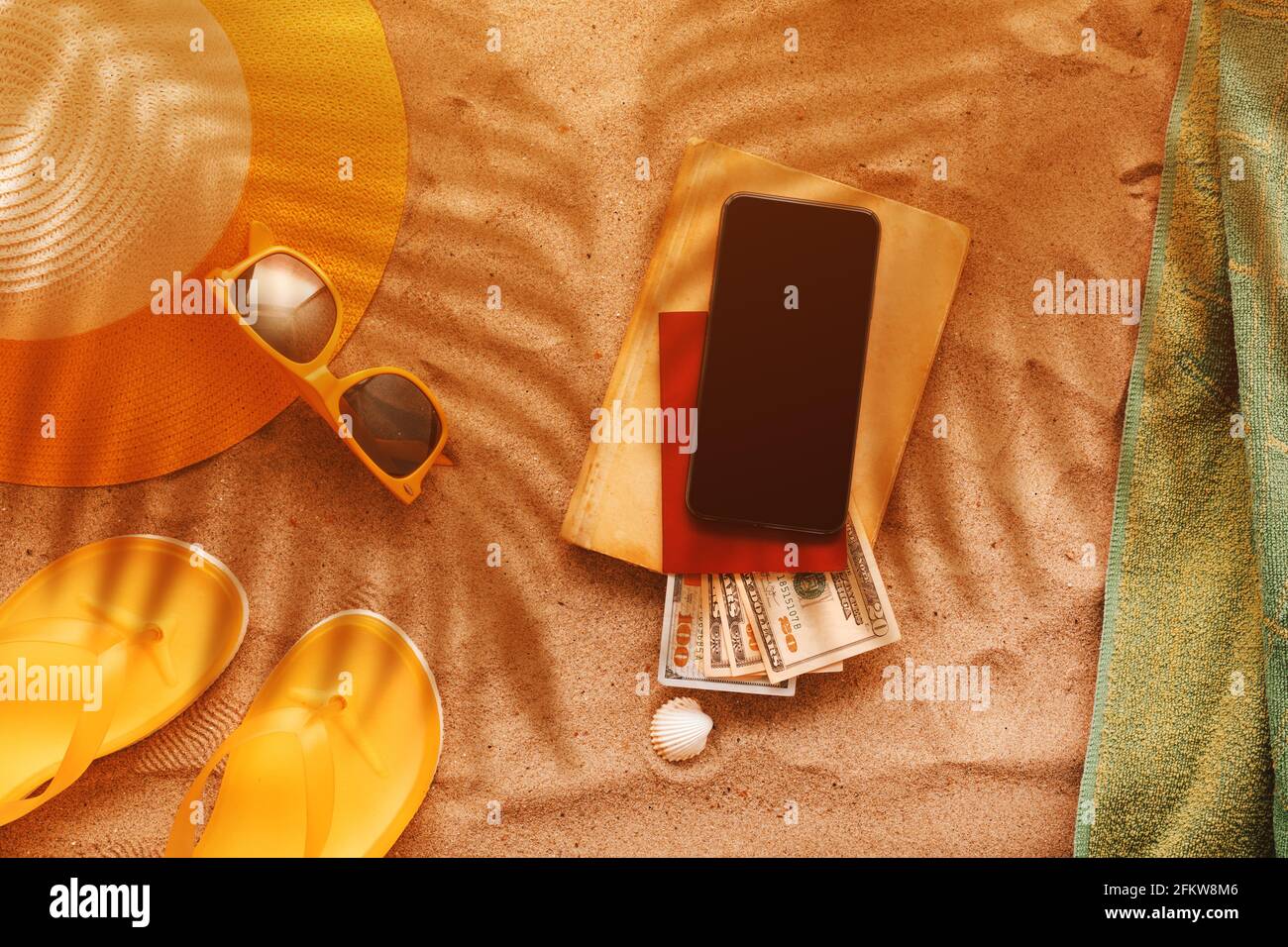 Summer holiday at sandy beach, flat lay top view with personal accessories at seaside and palm leaf shadows Stock Photo