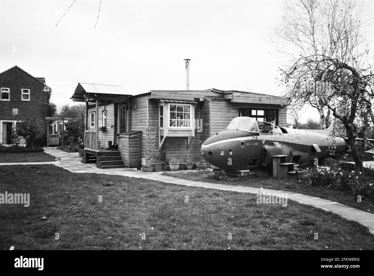 Jet Trainer aircraft and Log cabin style twin static caravan, Medstead, Hampshire, England, United Kingdom. Stock Photo