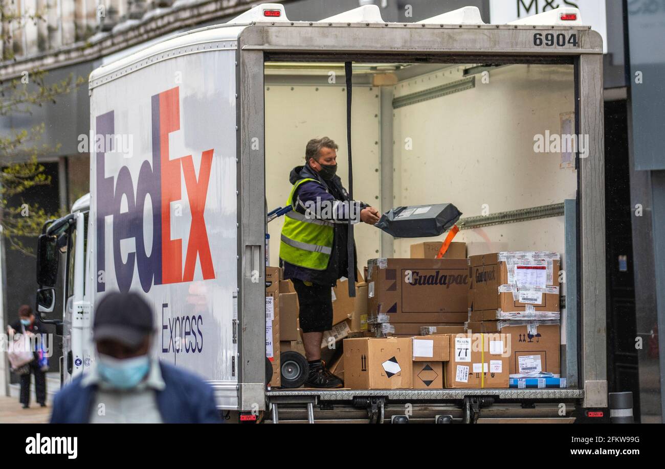 FEDEX parcel lorry delivery driver in Preston, Lancashire;  May, 2021 UK Weather;  FedEx Store deliveries in the city centre as stores replenish bank holiday sales stock Credit; ZarkePics/AlamyLiveNews Stock Photo