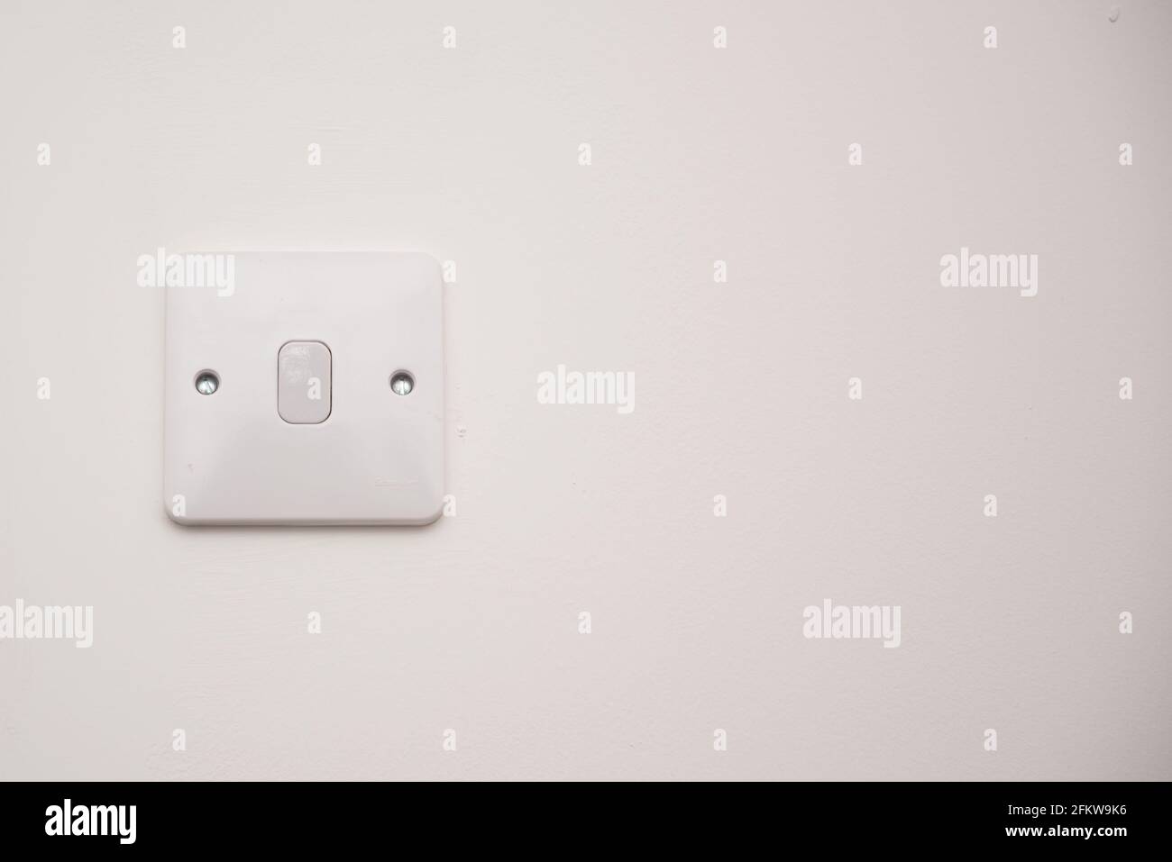 Light switch on a white wall Stock Photo