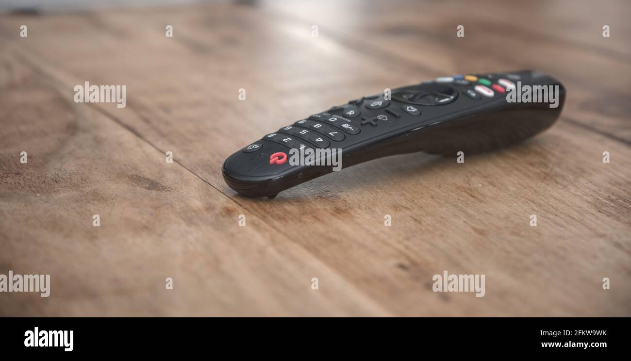 TV remote control on wooden table Stock Photo