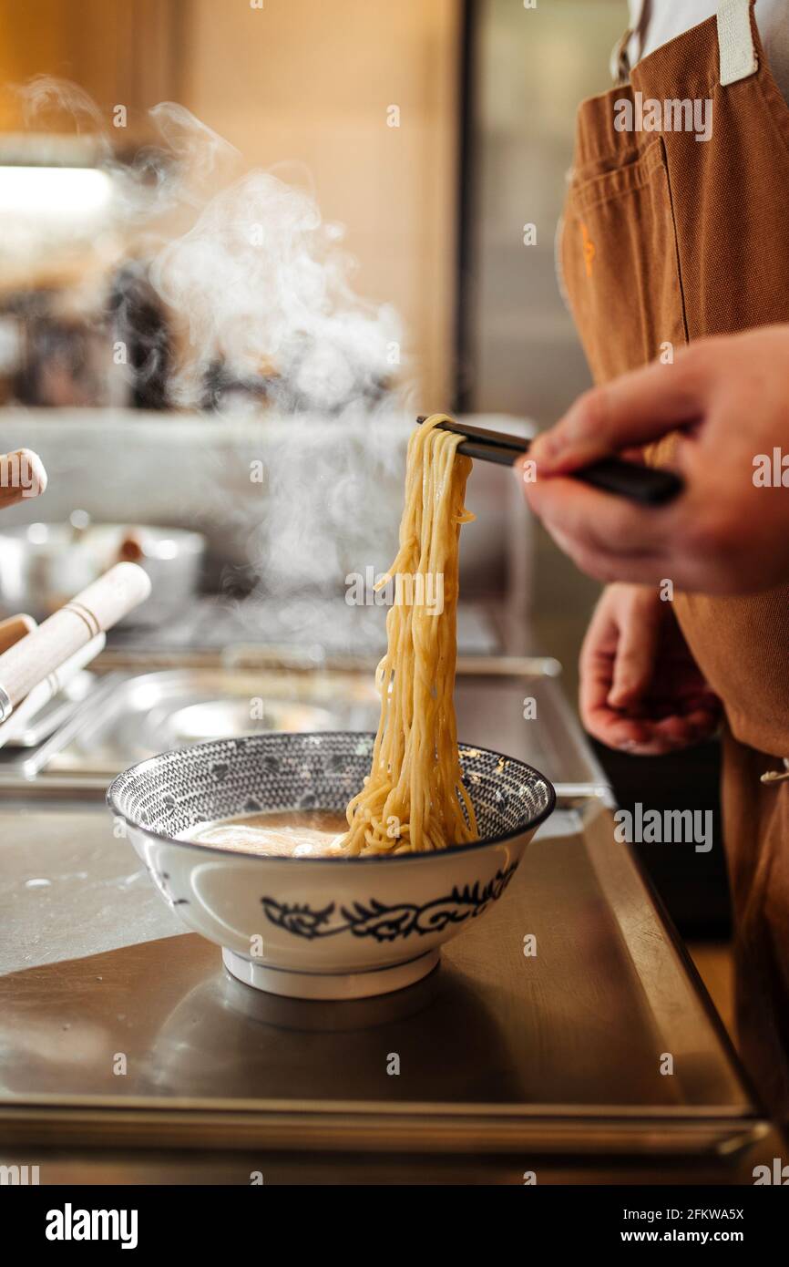 Cooking japanese ramen soup with adding noodles Stock Photo Alamy