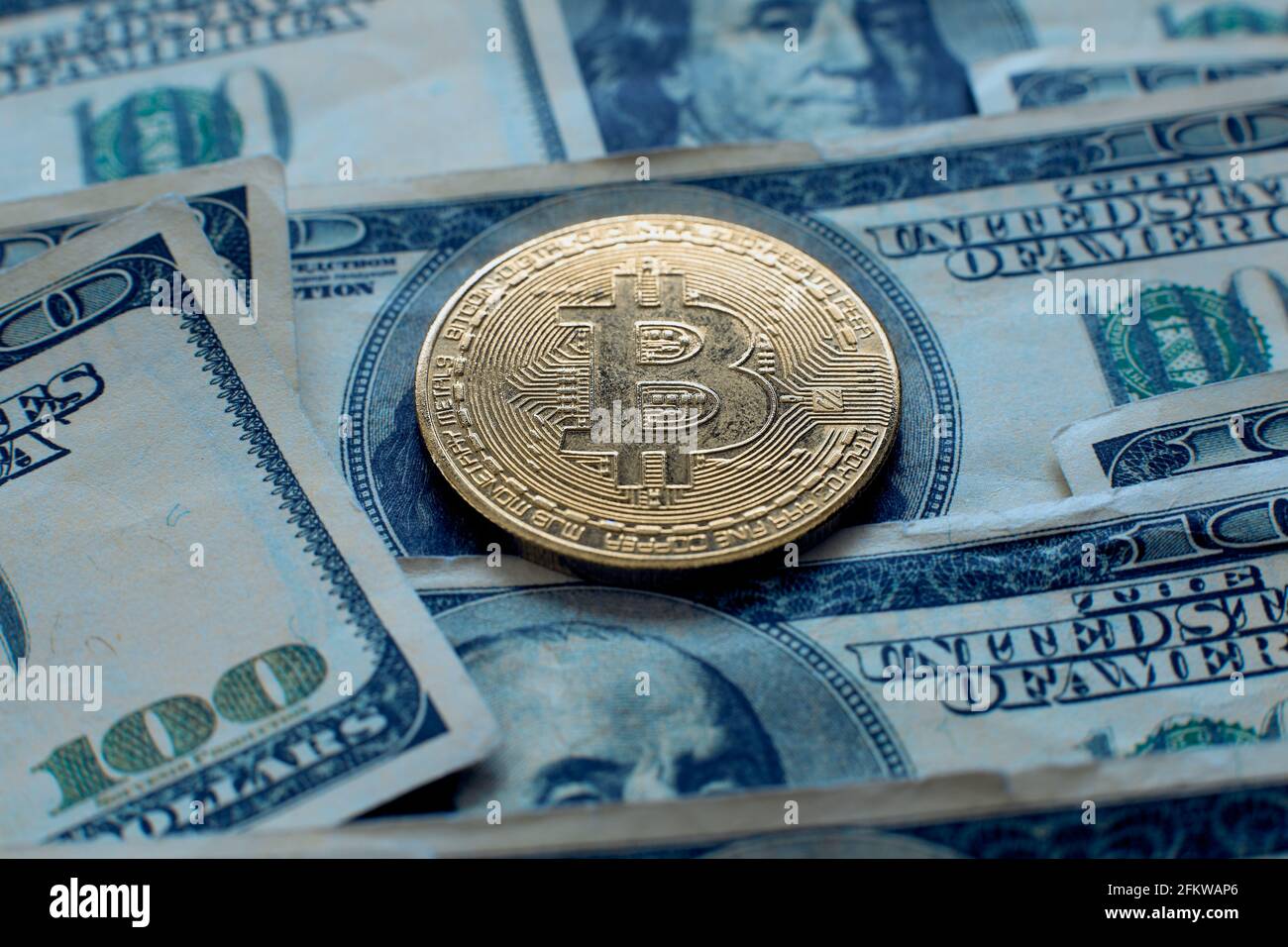 Golden Bitcoin and dollar bills lies on a blue jeans fabric. New virtual  money. New crypto currency in the form of the coins Stock Photo - Alamy