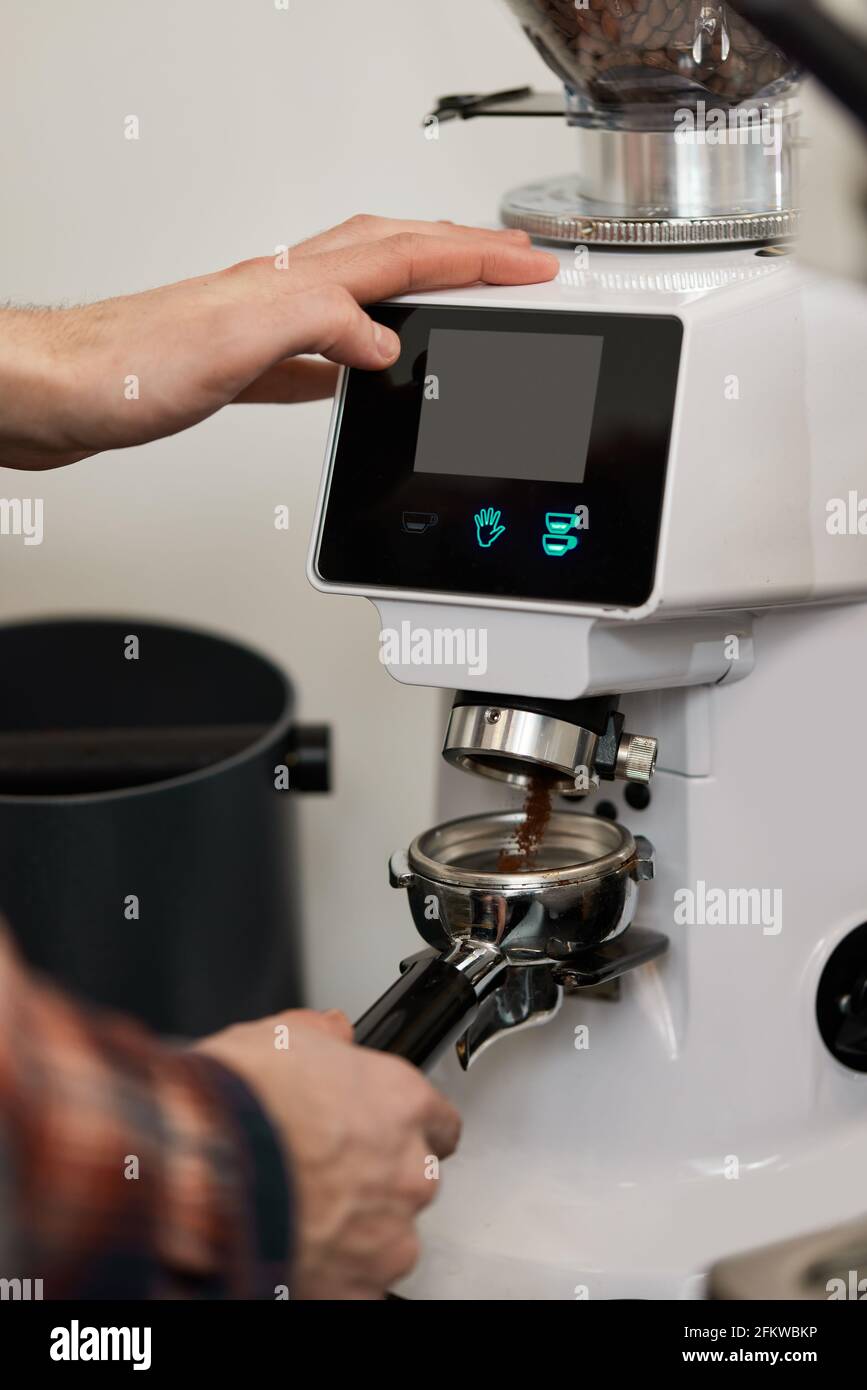 Barista using a coffee machine to make coffee Stock Photo