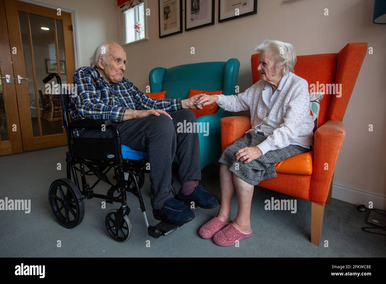 Elderly couple in their eighties reunited in a care come after being separated for several weeks due to the Coronavirus Pandemic, Hampshire, England. Stock Photo