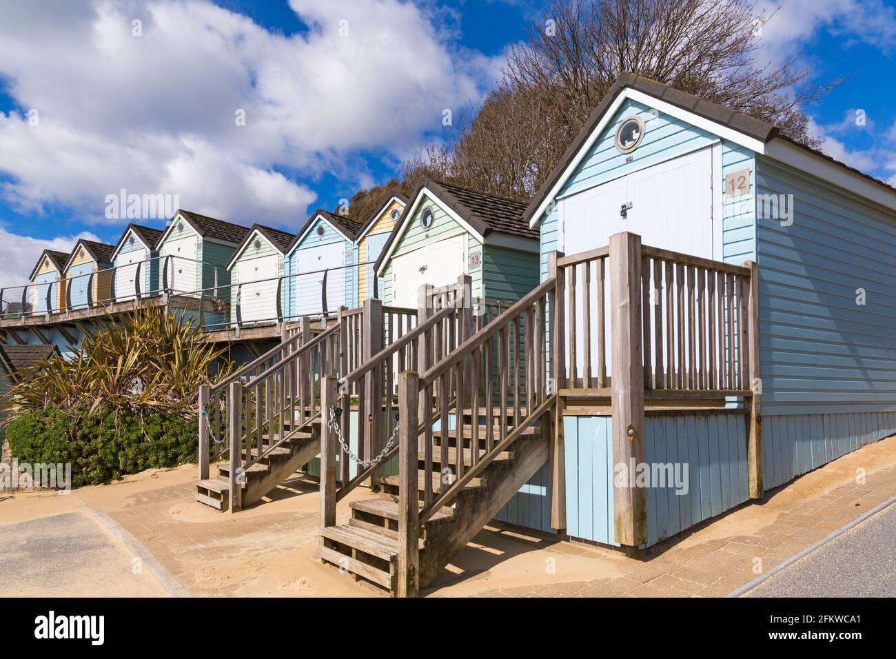 Bournemouth, Dorset UK. 4th May 2021. UK weather: after a stormy night the sun returns for a windy and sunny morning at Bournemouth beach, as few visitors head to the seaside. Beach huts at Alum Chine.  Credit: Carolyn Jenkins/Alamy Live News Stock Photo