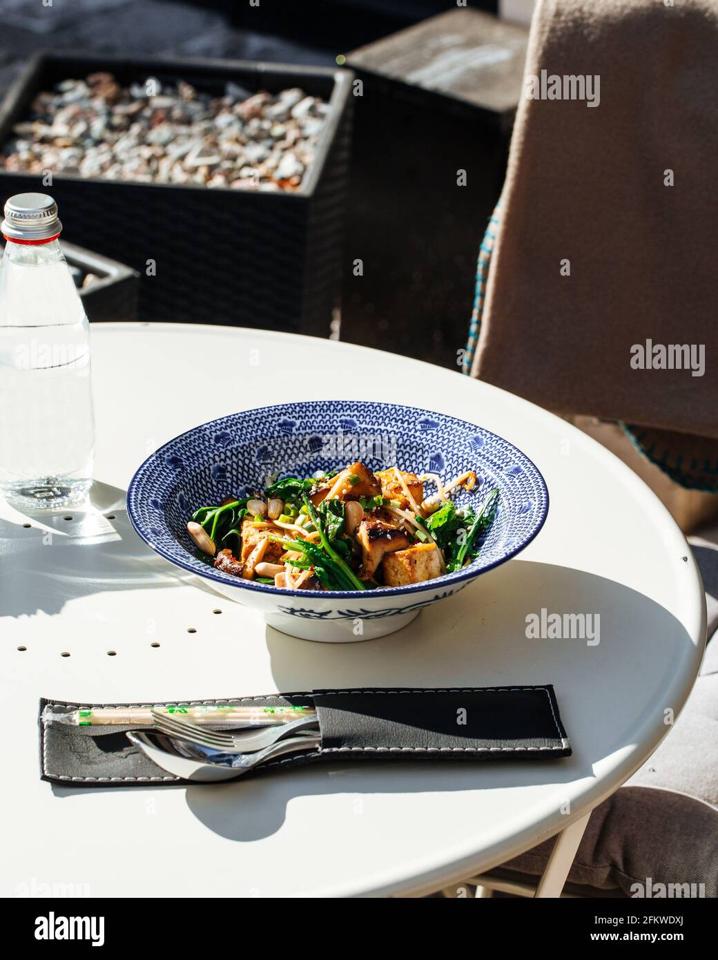 Table served with fried tofu with spinach and nuts Stock Photo