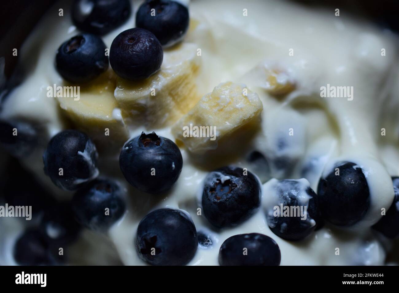 Close up of blueberries and pieces of banana in yoghurt Stock Photo