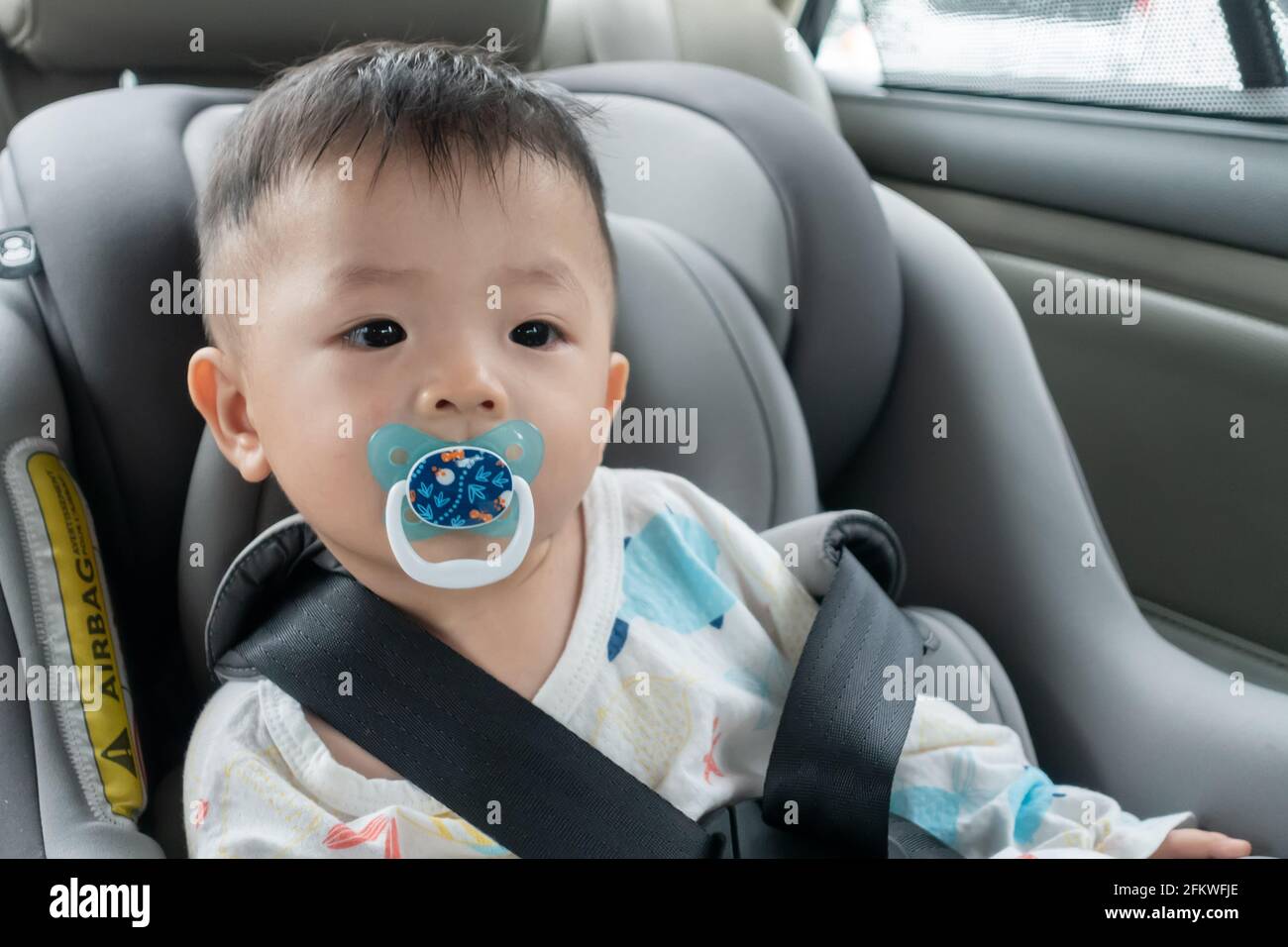 Local lifestyle Asian Chinese baby boy with emotion face and sucking