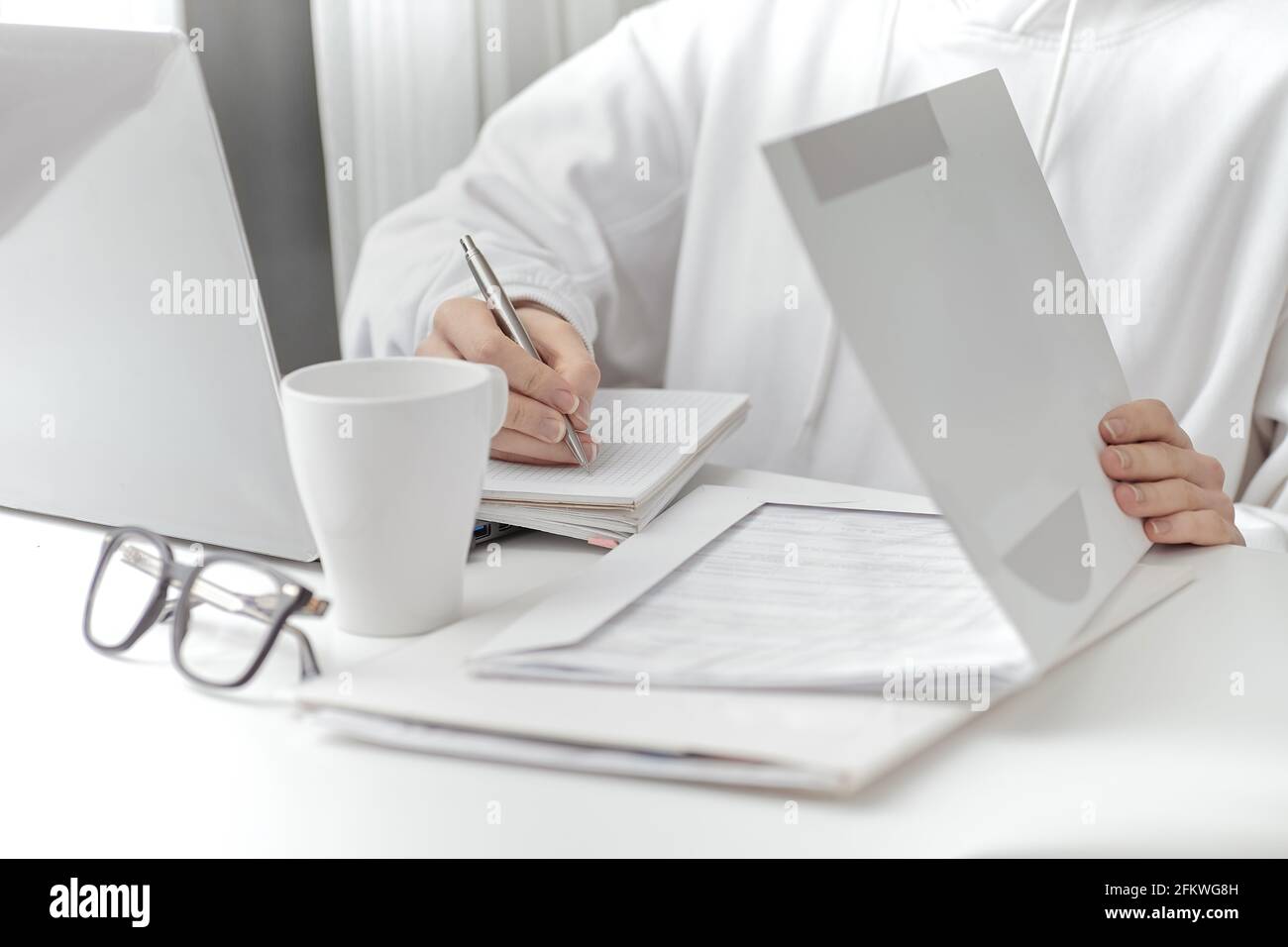 A female make a note at work. Close-up Stock Photo