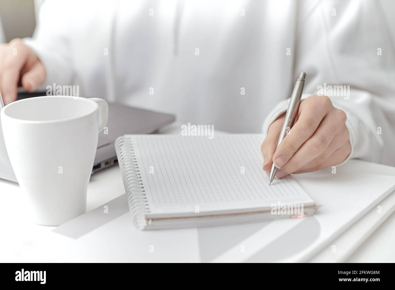 A female make a note at work. Close-up Stock Photo