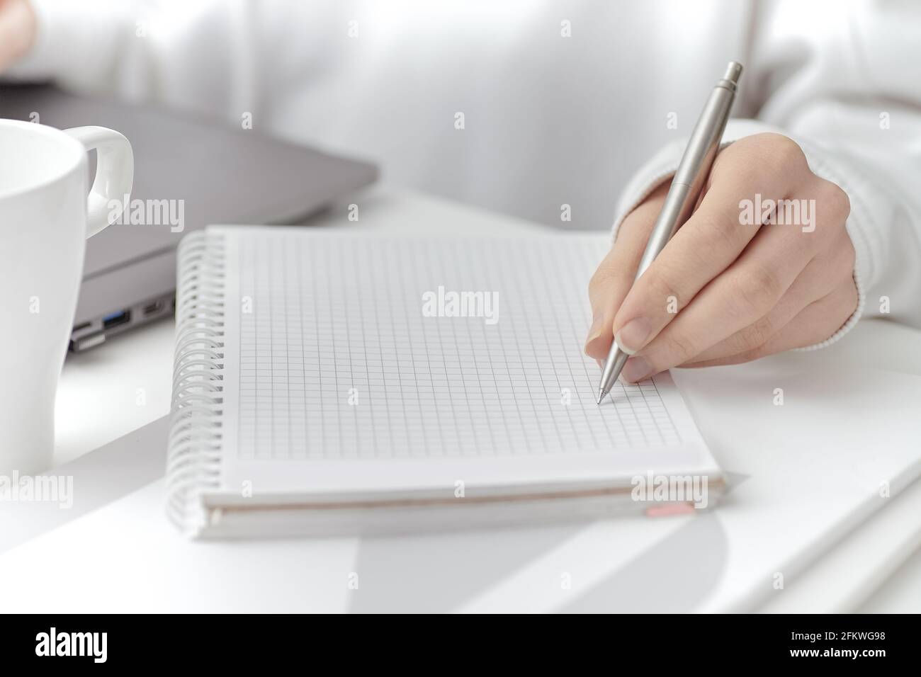 A female make a note at work. Close-up Stock Photo