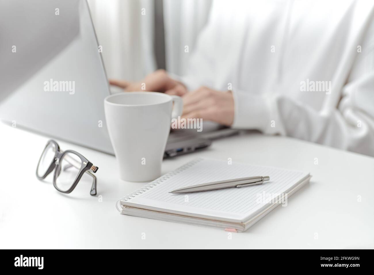 A female make a note at work. Close-up Stock Photo
