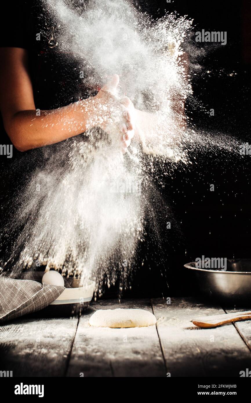 Baker hand with flour pizza preparation Stock Photo Alamy
