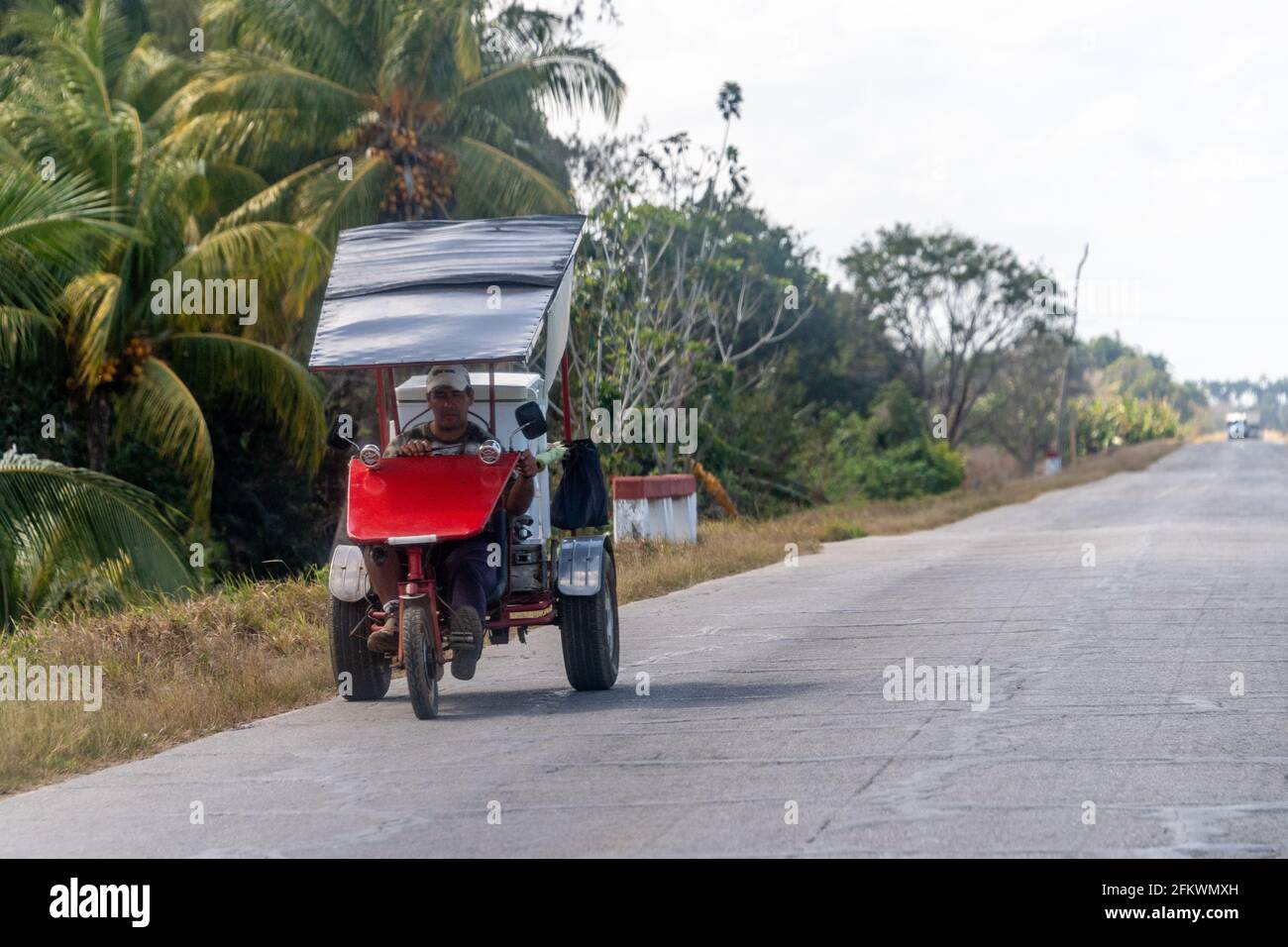Bici-taxi or pedicab in rural road, Cuba Stock Photo