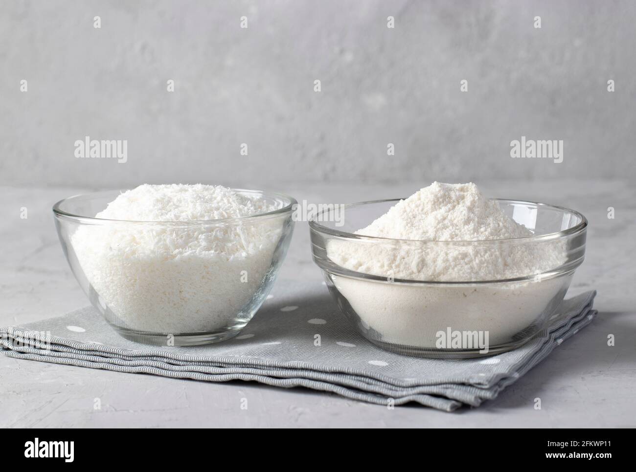 Vegan coconut products coconut flakes and flour in transparent bowls