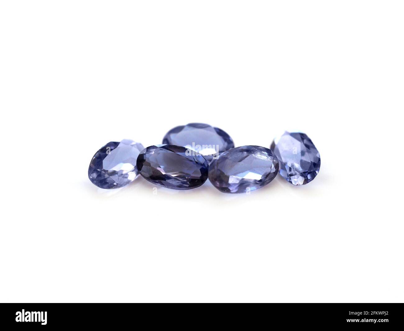 Iolite gemstone oval shaped on a white background Stock Photo