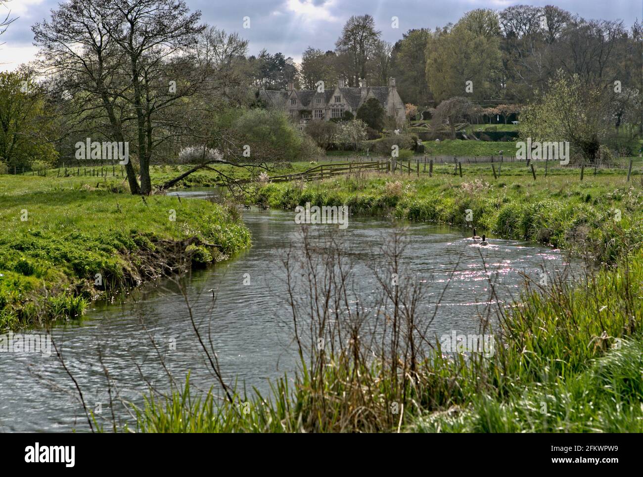 Asthall Manor in Asthall, Oxfordshire, is sited on the River Windrush. Stock Photo