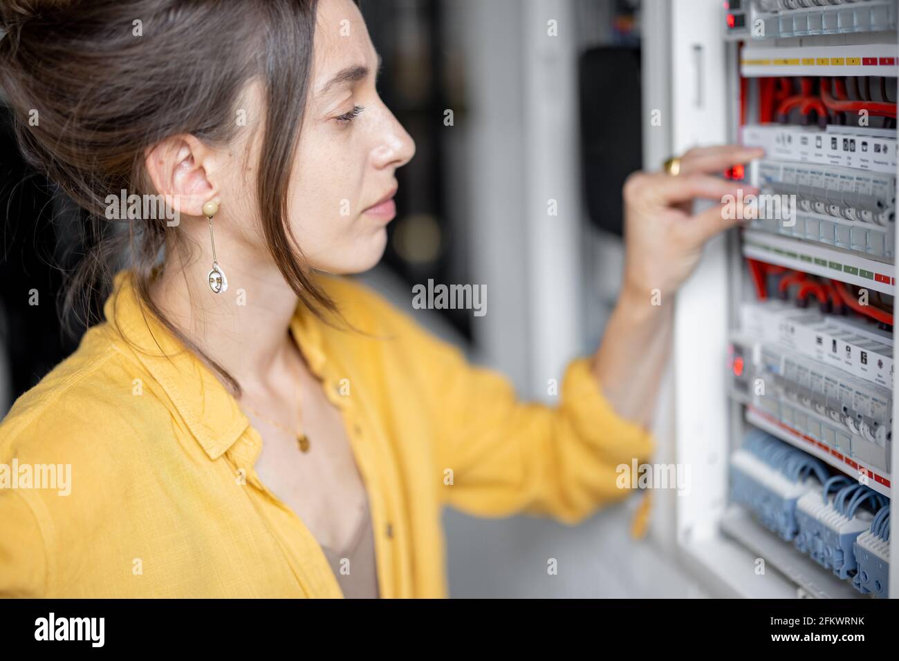 Confused woman having problems with electricity at home, speaks on the