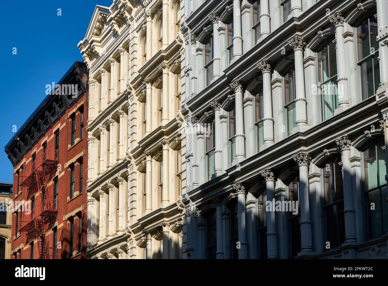 Typical building facades in SoHo, the Cast Iron Historic District with distinct late 19th centtury architecture. Manhattan, New York City, USA Stock Photo