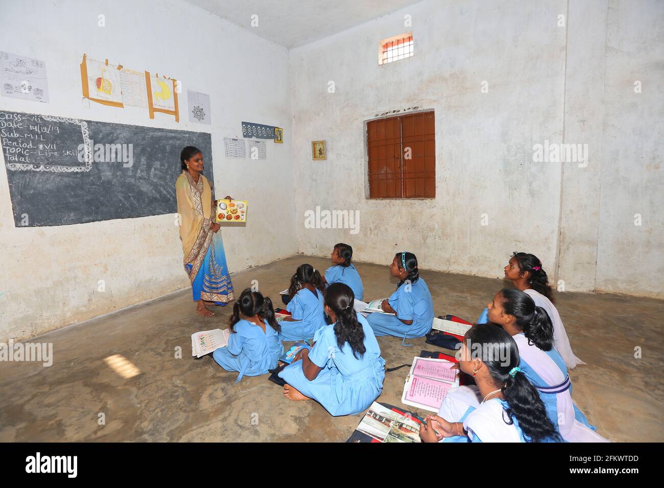 Middle school tribal teacher teaching girls in classroom . DESIA KONDHA TRIBE. Odisha, India Stock Photo