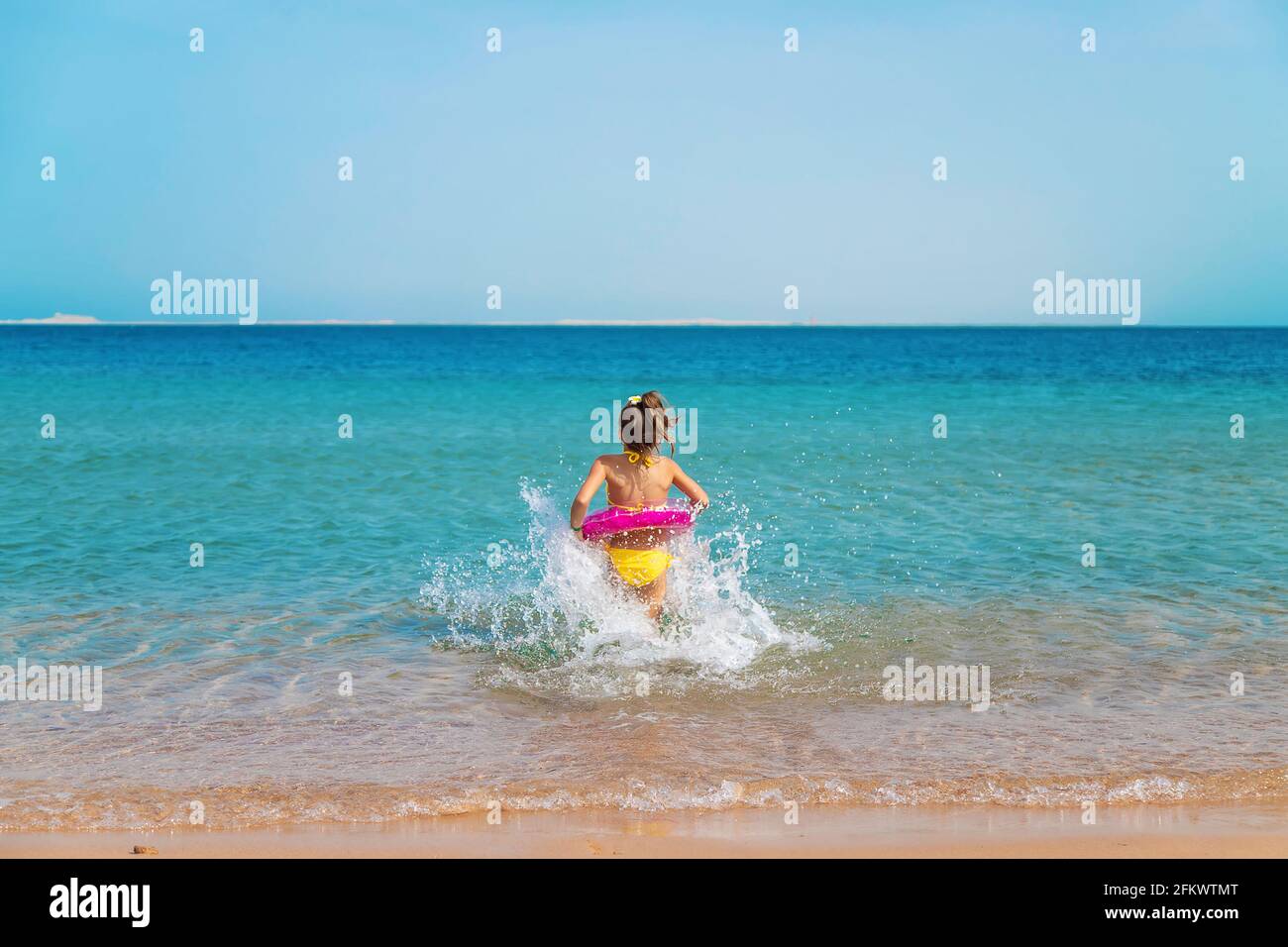 The child swims in a circle in the sea. 