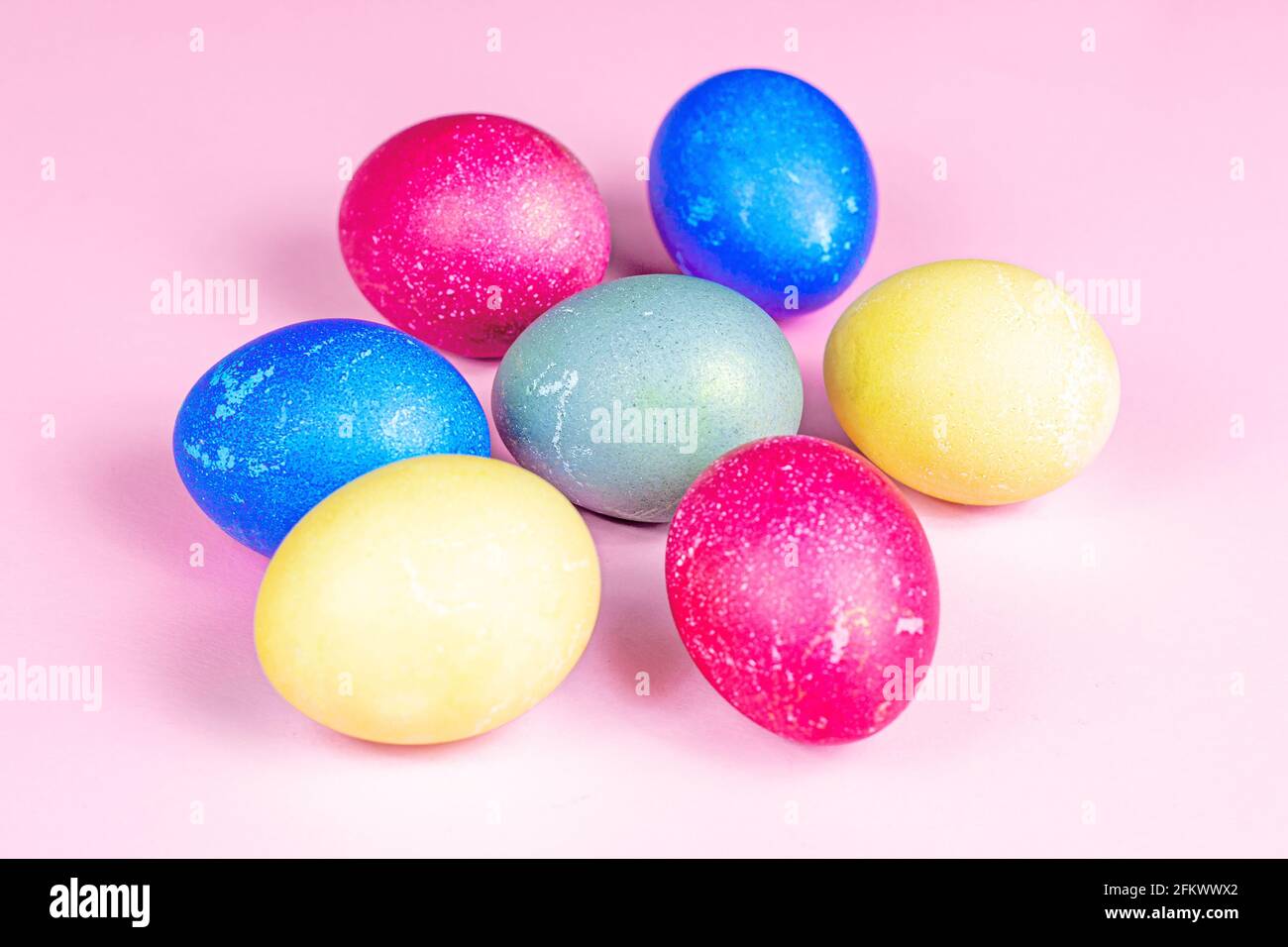 Colorful painted Easter eggs decorations on light pink background. Stock Photo