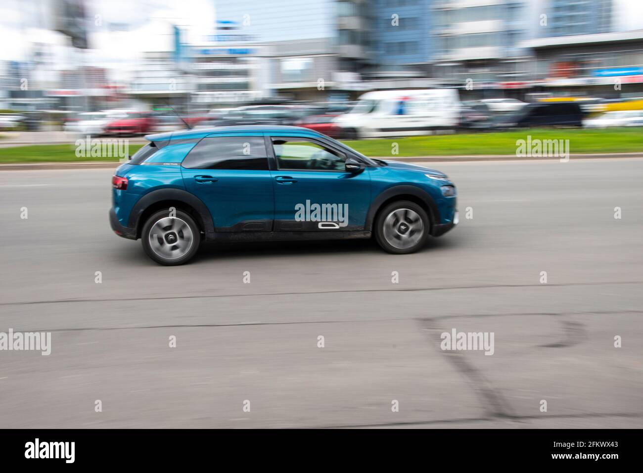 Ukraine, Kyiv - 26 April 2021: Blue Citroen C4 Cactus car moving on the street. Editorial Stock Photo