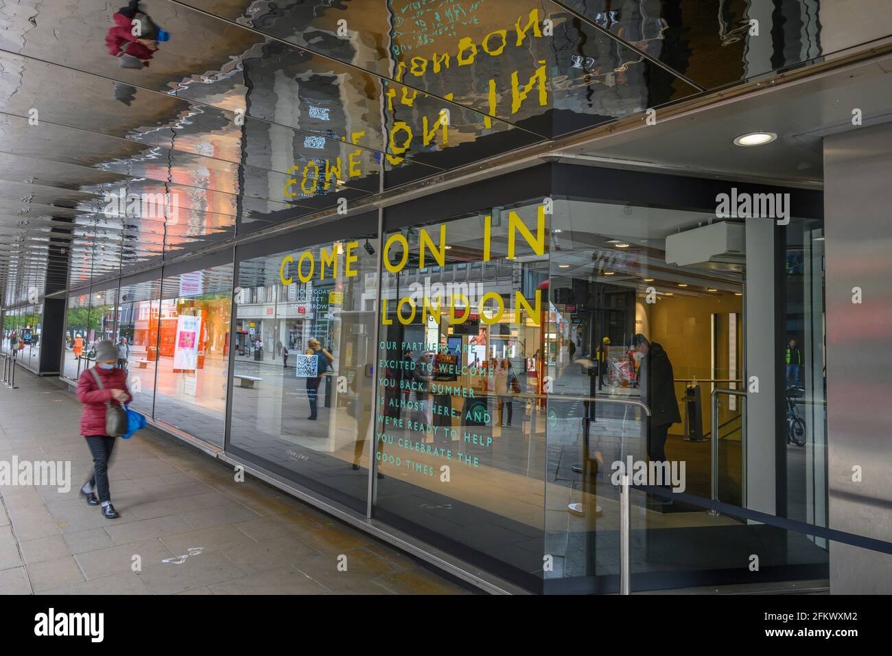 Oxford Street, London, UK. 4 May 2021. Pedestrian walks under the ...