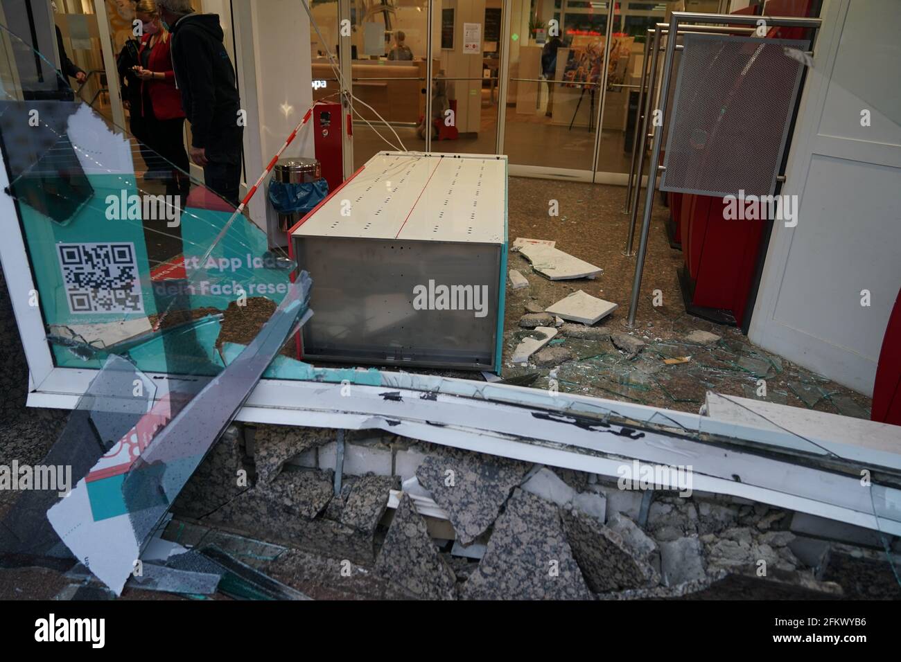 Hamburg, Germany. 04th May, 2021. Shards of glass and stones of a destroyed shop window frame lie after an accident in a Haspa branch. In Waitzstraße in Hamburg, which is known for numerous 'shop window accidents', a car has once again crashed into the window of a shop. On Tuesday, a 73-year-old woman lost control of her car and crashed it into the building housing the Hamburg savings bank Haspa, a police spokesman told the Deutsche Presse-Agentur in Hamburg. Credit: Marcus Brandt/dpa/Alamy Live News Stock Photo
