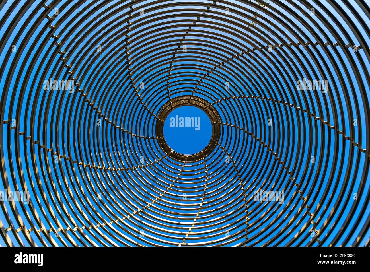 Abstract metal structure in the form of circles against the blue sky ...