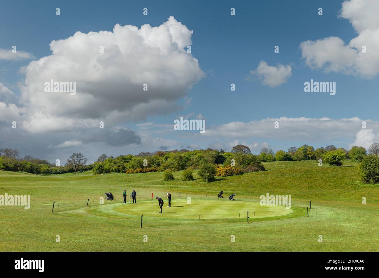 View across public parkland and golf course with golfers  on bright morning in spring  in Beverley, Yorkshire, UK. Stock Photo