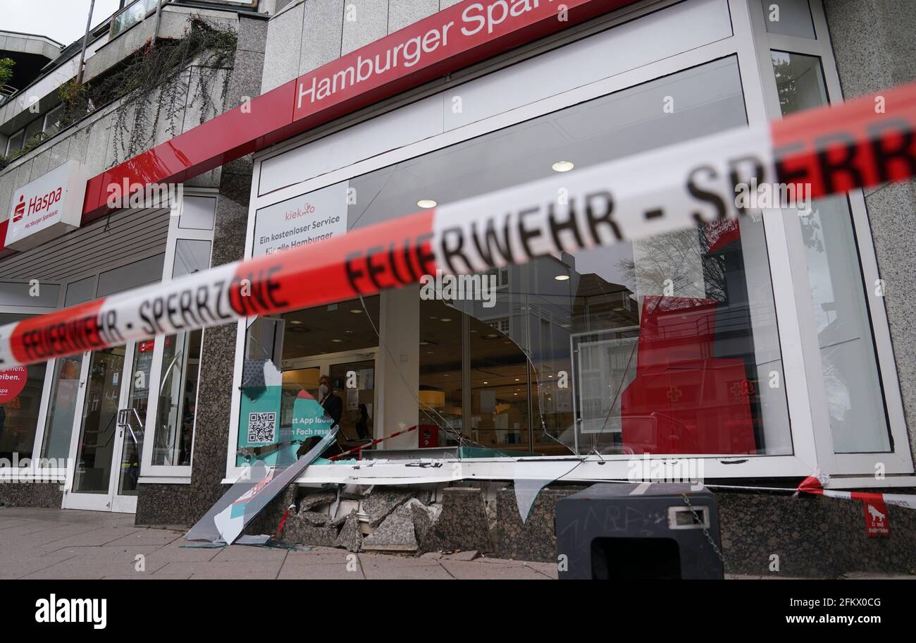 Hamburg, Germany. 04th May, 2021. Shards of glass and stones of the destroyed shop window frame lie in front of and inside a Haspa branch after an accident. In Waitzstraße in Hamburg, which is known for numerous 'shop window accidents', a car has once again crashed into the window of a shop. On Tuesday, a 73-year-old woman had lost control of her car and crashed it into the building housing the Hamburg savings bank Haspa, a police spokesman told the Deutsche Presse-Agentur in Hamburg. Credit: Marcus Brandt/dpa/Alamy Live News Stock Photo