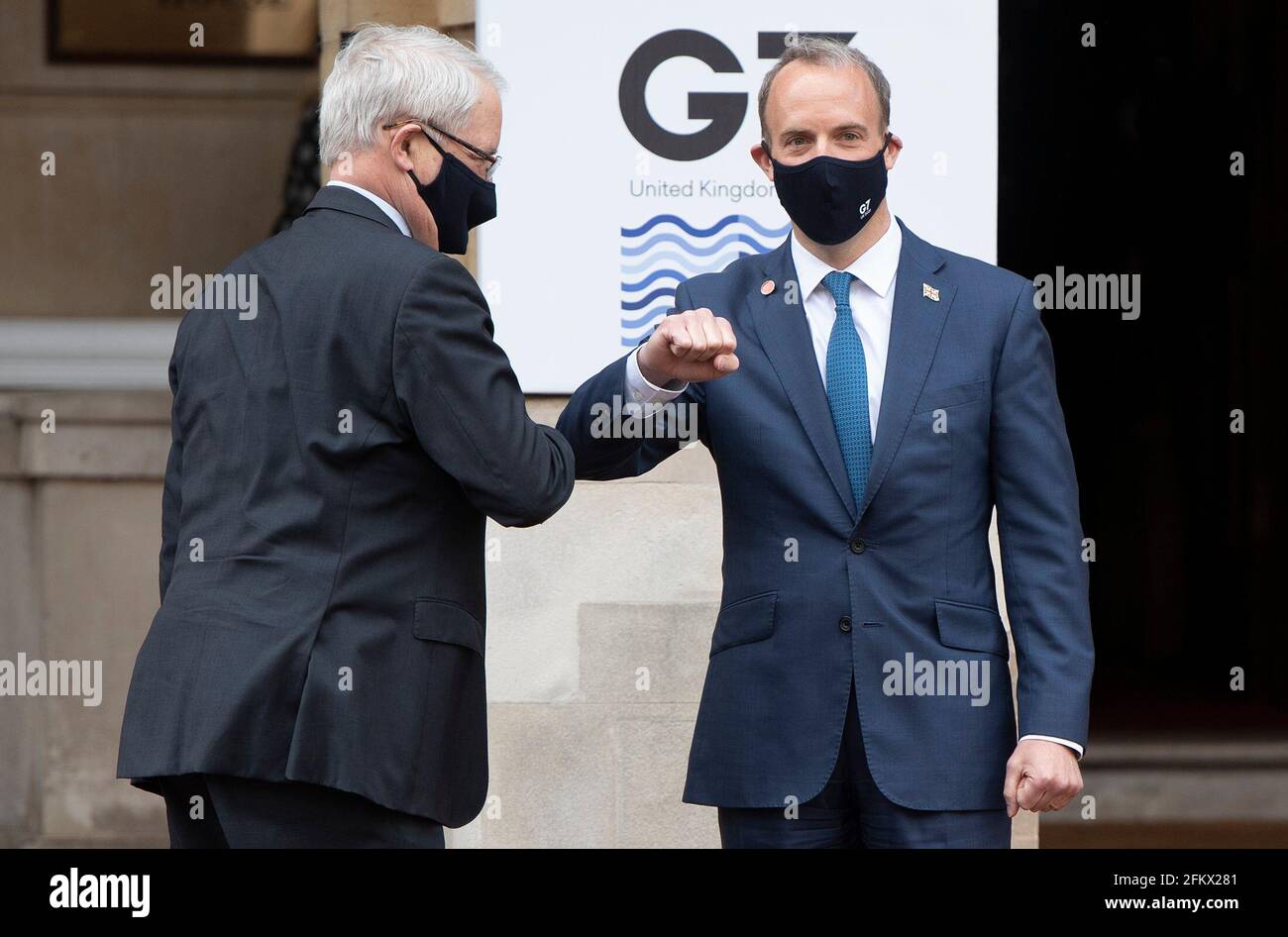 Foreign Secretary Dominic Raab (right) greets Canadian Minister of Foreign Affairs Marc Garneau, as he arrives at Lancaster House in London for talks with fellow foreign ministers from the G7 Foreign and Development Ministers meeting. Picture date: Tuesday May 4, 2021. Stock Photo