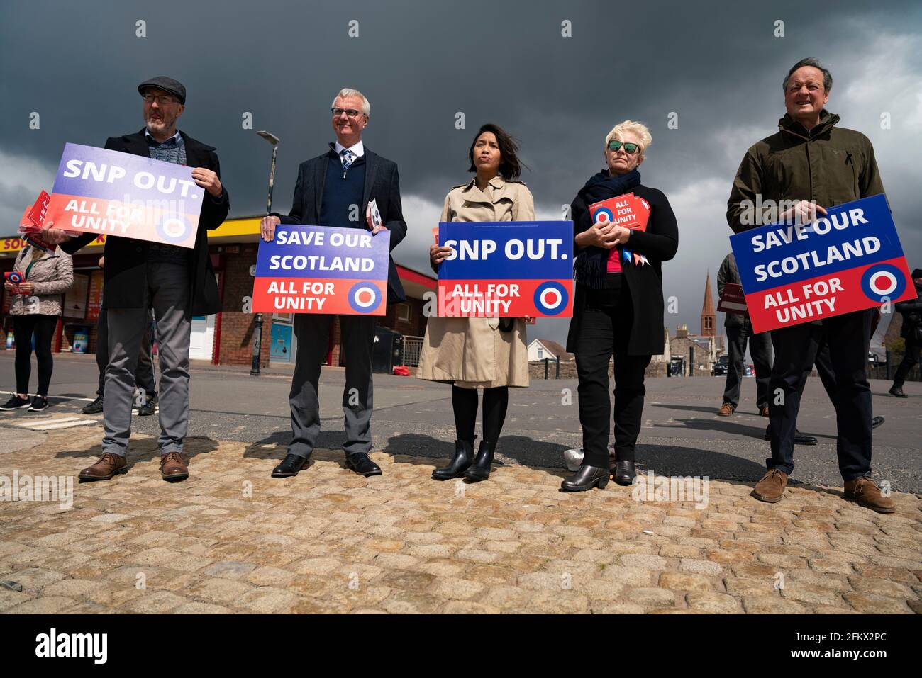 Troon, Scotland, UK. 4 May 2021. Founder of  pro Union All for Unity party George Galloway campaigns on the beach promenade in Troon in Ayrshire. Galloway made a live streamed speech and met with supporters and members of the public. He had lunch of fish and chips at The Wee Hurrie takeaway restaurant beside Troon harbour. Iain Masterton/Alamy Live News Stock Photo