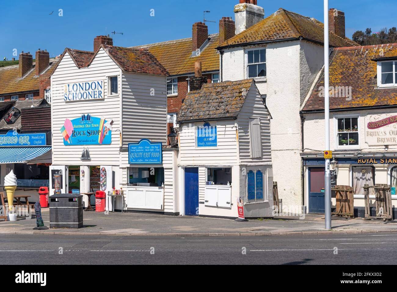 Old white weather boarded shops in Hastings Stock Photo