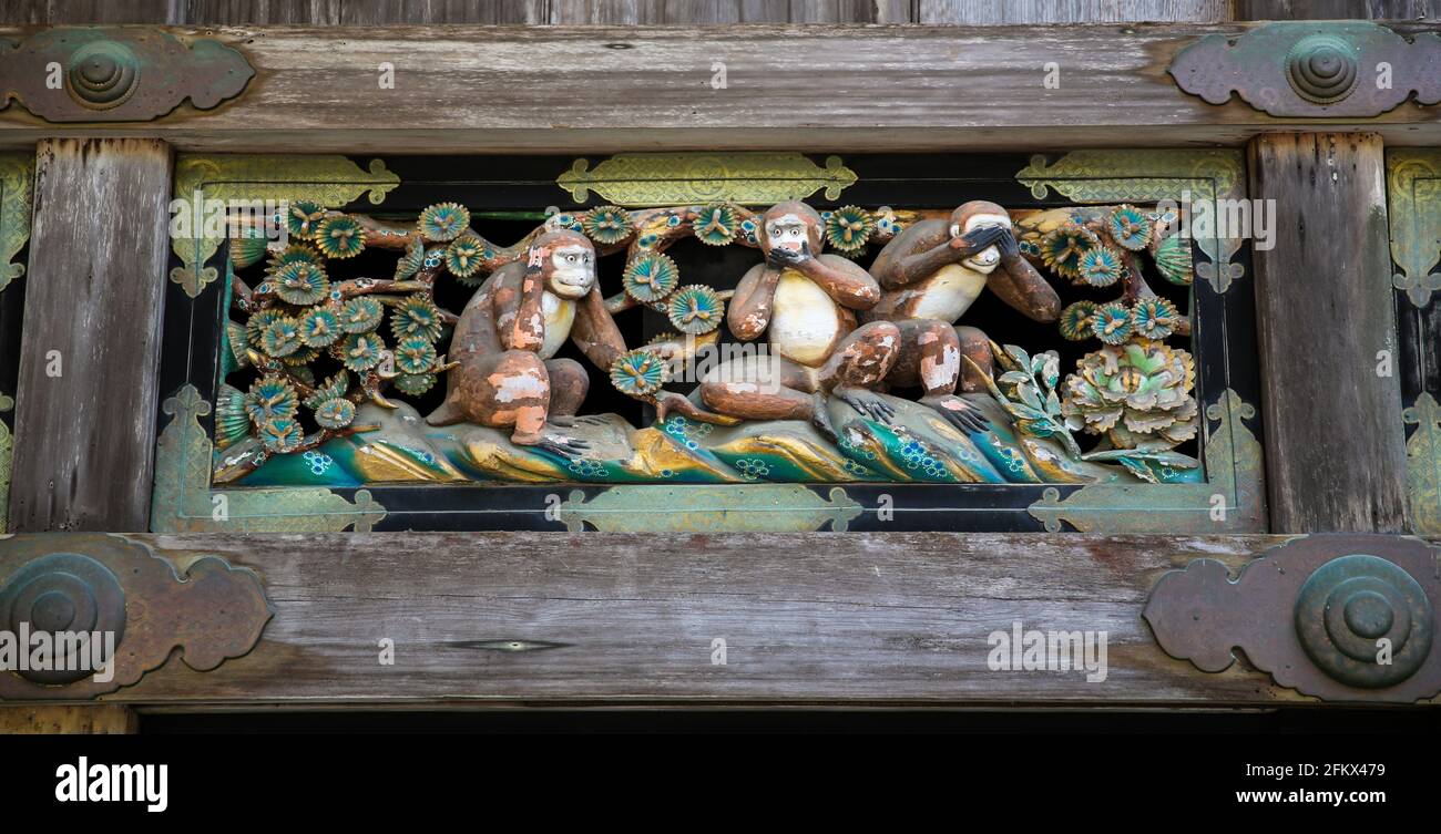 Sanzaru or Three Wise Monkeys, a wooden pictorial maxim at Toshogu Shinto Shrine in Nikko, Japan. See no evil, hear no evil, speak no evil. Stock Photo