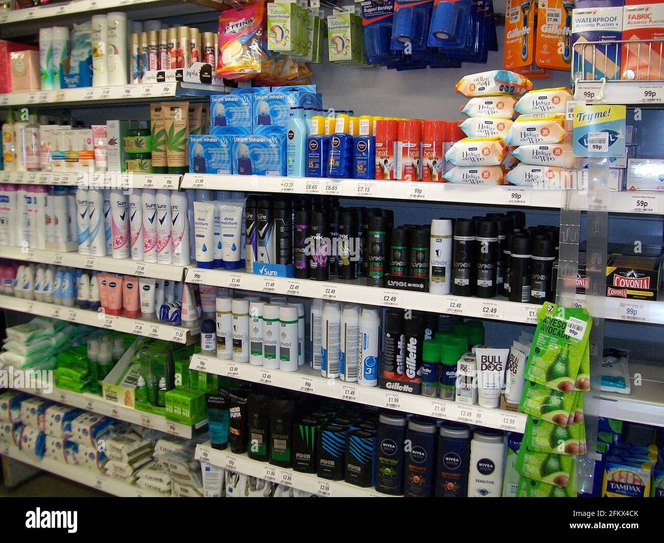 Supermarket shelves with mens and womens toiletries items for sale Stock Photo