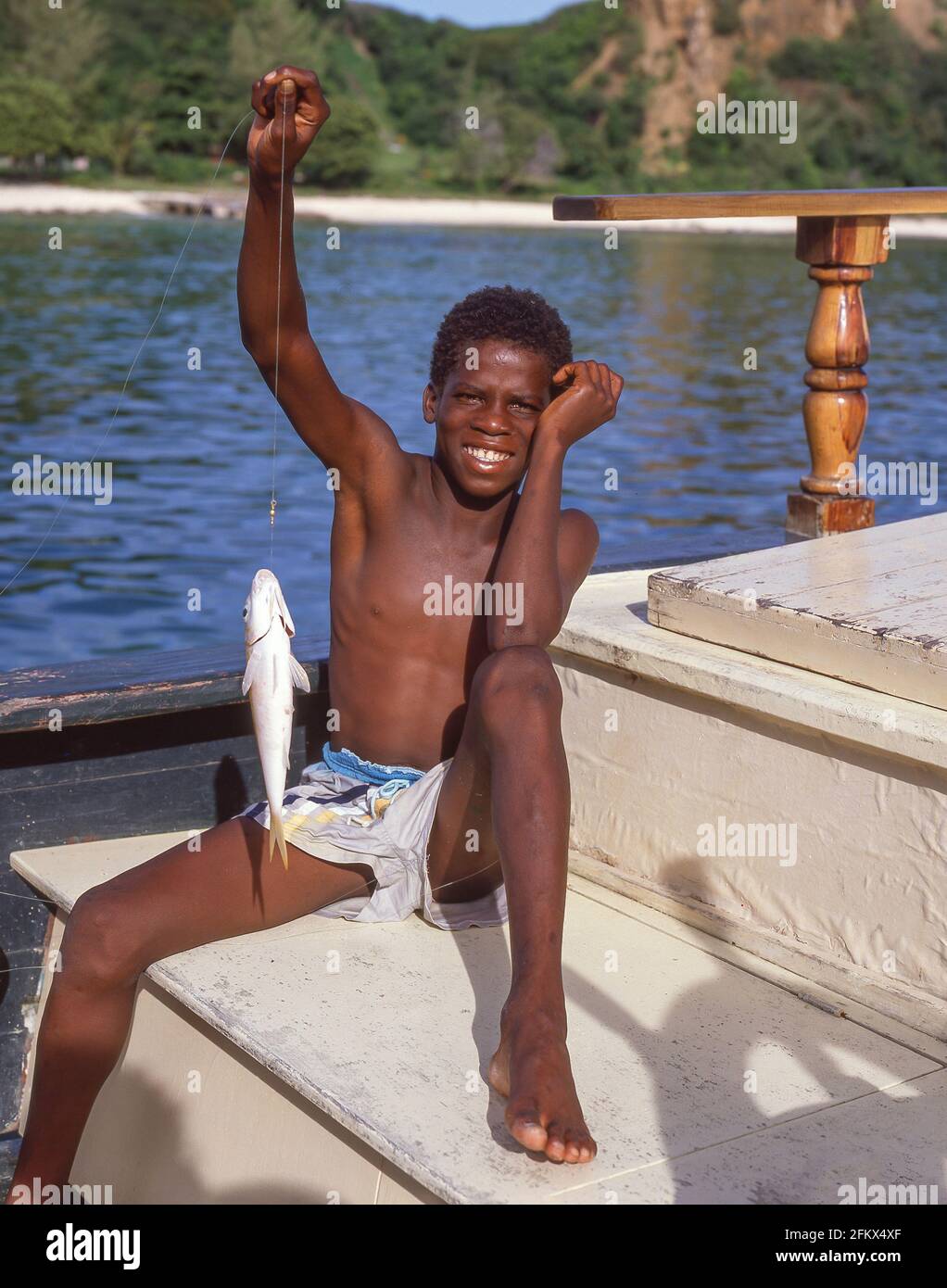 Young boy holding fish catch, St. Kitts, St. Kitts and Nevis, Lesser Antilles, Caribbean Stock Photo